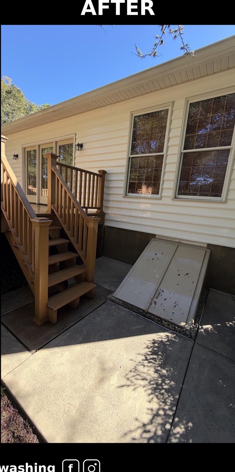 The same cellar door and concrete after washing, clean and dry