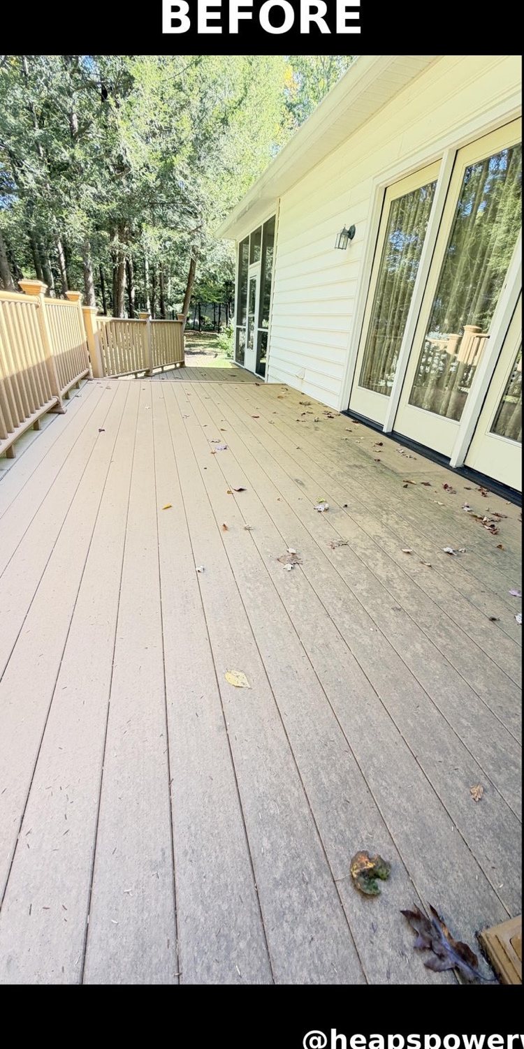 Composite deck boards gray with dirt and leaves before washing