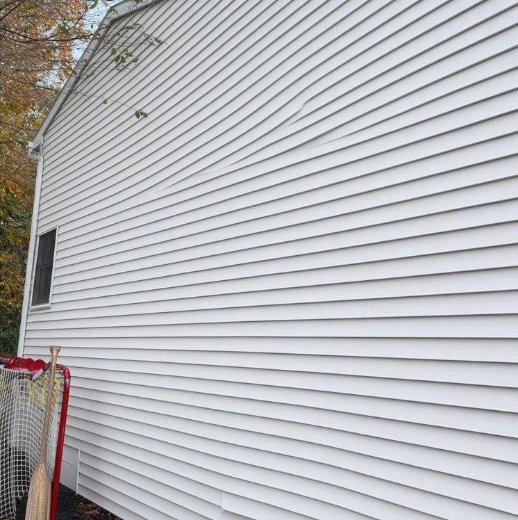 The same vinyl siding after washing, bright white